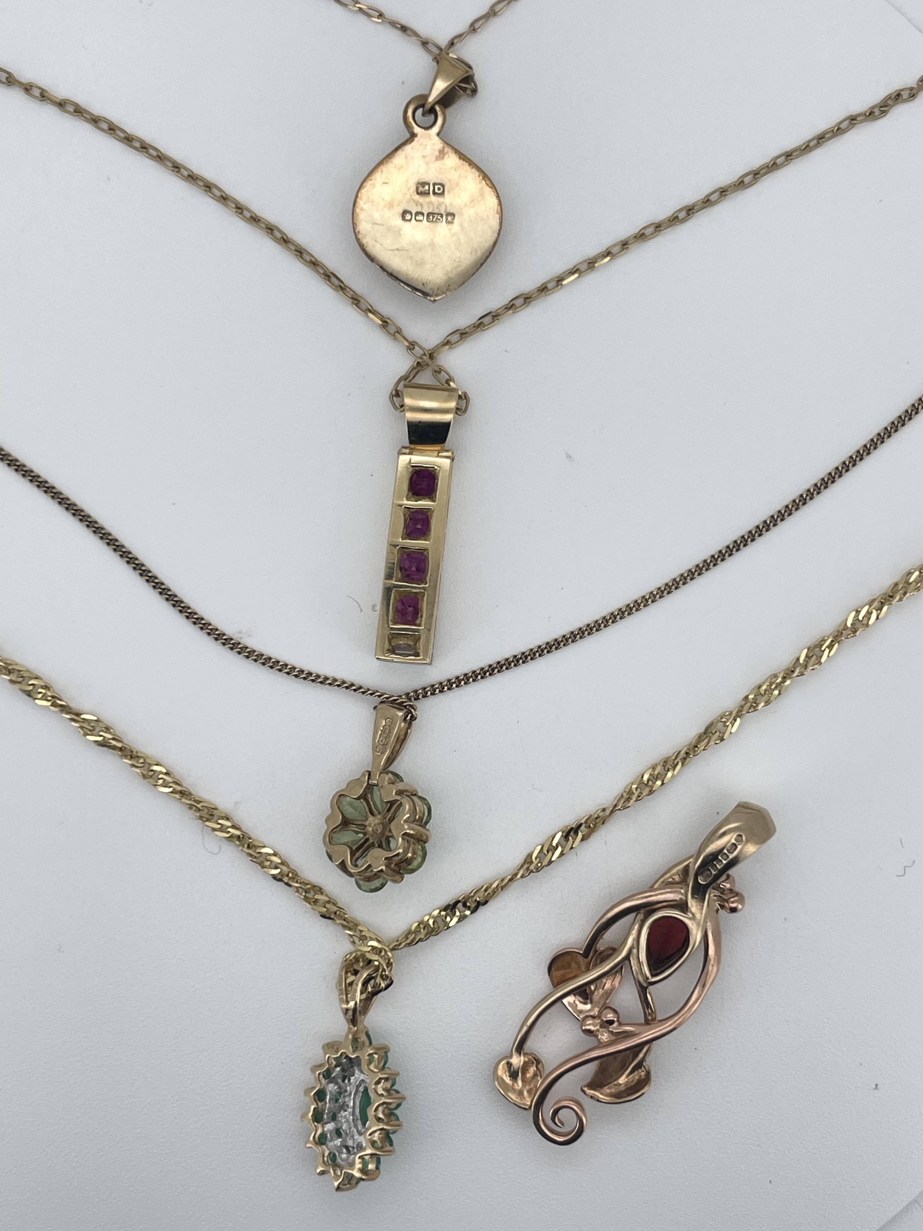 Three assorted 9ct and gem set pendants on 9ct chains, including emerald and diamond navette shaped cluster and single stone white opal doublet?, together with an unmarked yellow metal and gem set line pendant on a 9ct c
